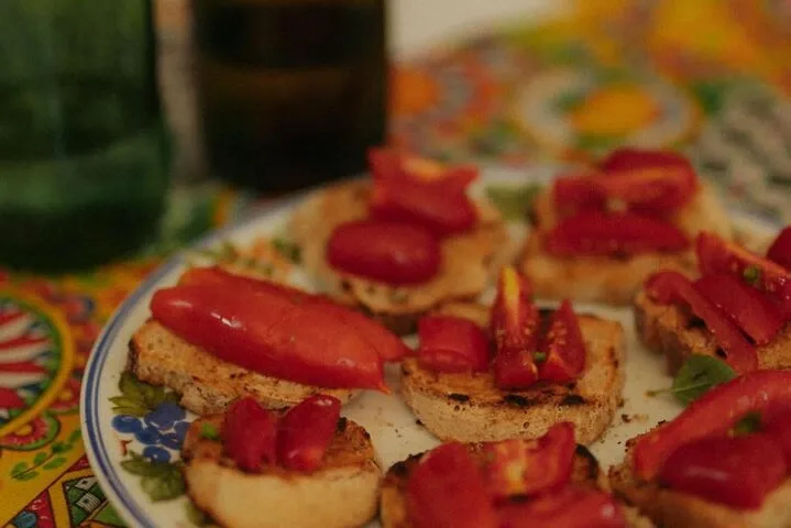 Bruschetta mit roter Paprika und Tomaten auf einem bemalten Teller