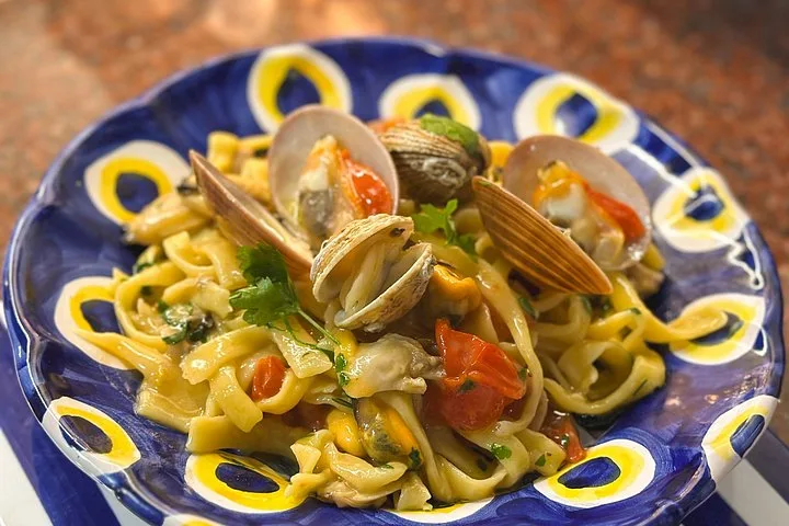 Tagliatelle with clams on a painted plate